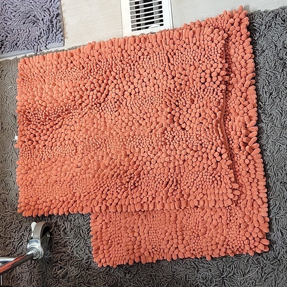 I am selling the two NWOT coral bath rugs.